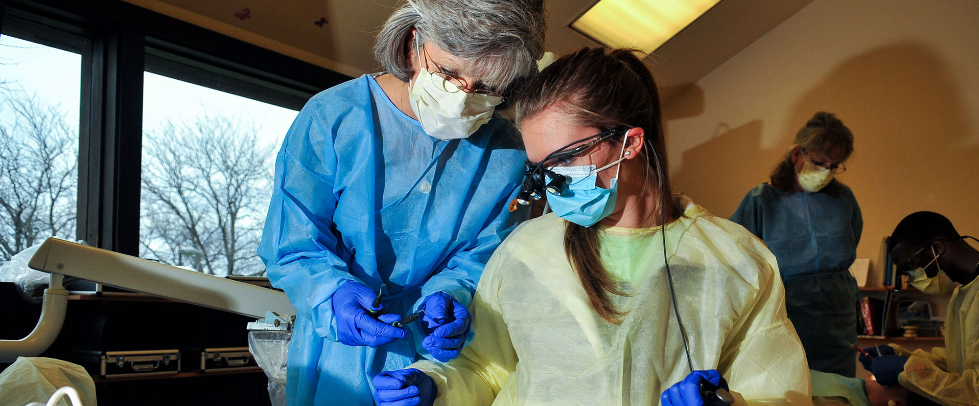 Dental teacher and Student in protective gear
